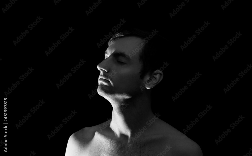 black and white photo portrait of a guy, in dramatic lighting