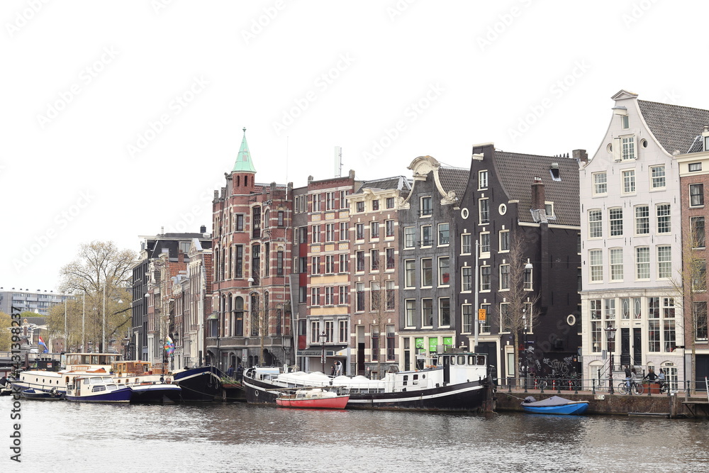 Amsterdam Amstel River View with Historical House Facades and Boats