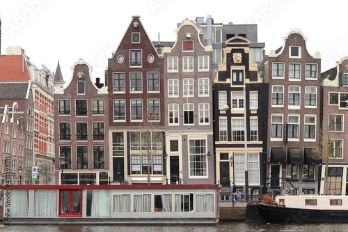 Amsterdam Amstel River View with Historical House Facades and Houseboats