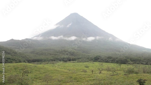 View of Arenal region in the morning, with mist over the green, lush forest and birds chirping