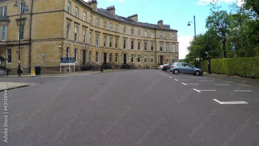 Panning From A Car The Historic Victorian Apartment Homes Of Downtown Glasgow'S Park Circus Neighborhood Along A Tree-Lined Street Panning From A Car The Historic Victorian Apartment Homes Of Downtown Glasgow'S Park Circus Neighborhood Along A Tree-Lined Street