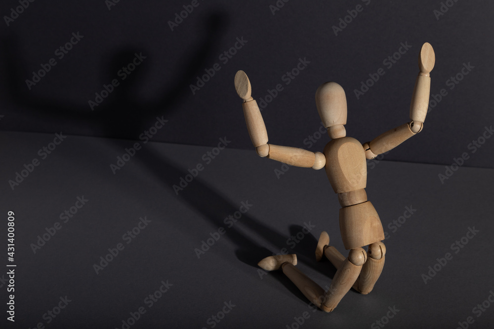 Wooden mannequin in imploration, praying position on gray background. religion concept. copy space. Wooden mannequin in imploration, praying position on gray background. religion concept. copy space.