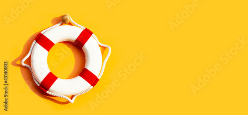 Lifebuoy on yellow background.