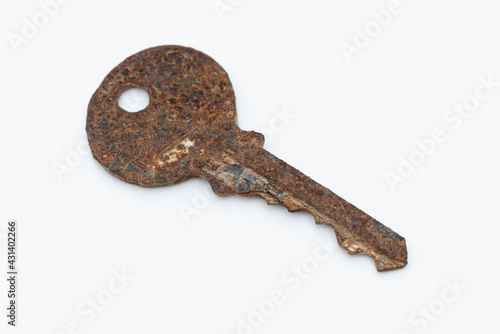 Old rusty key isolated on white background.
