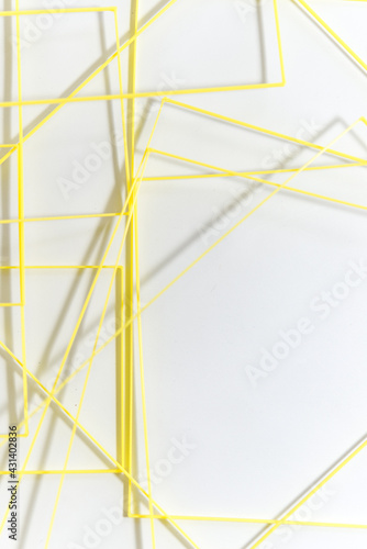 variously sized, yellow PLA filament, 3D printed squares randomly gathered on a white-grey background