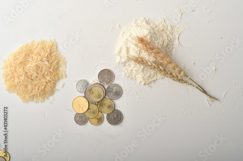Money , rosary, dates coin stacked , and rice on wooden background. Zakat Concept. Zakat is the sharing of wealth from the rich for the less fortunate.