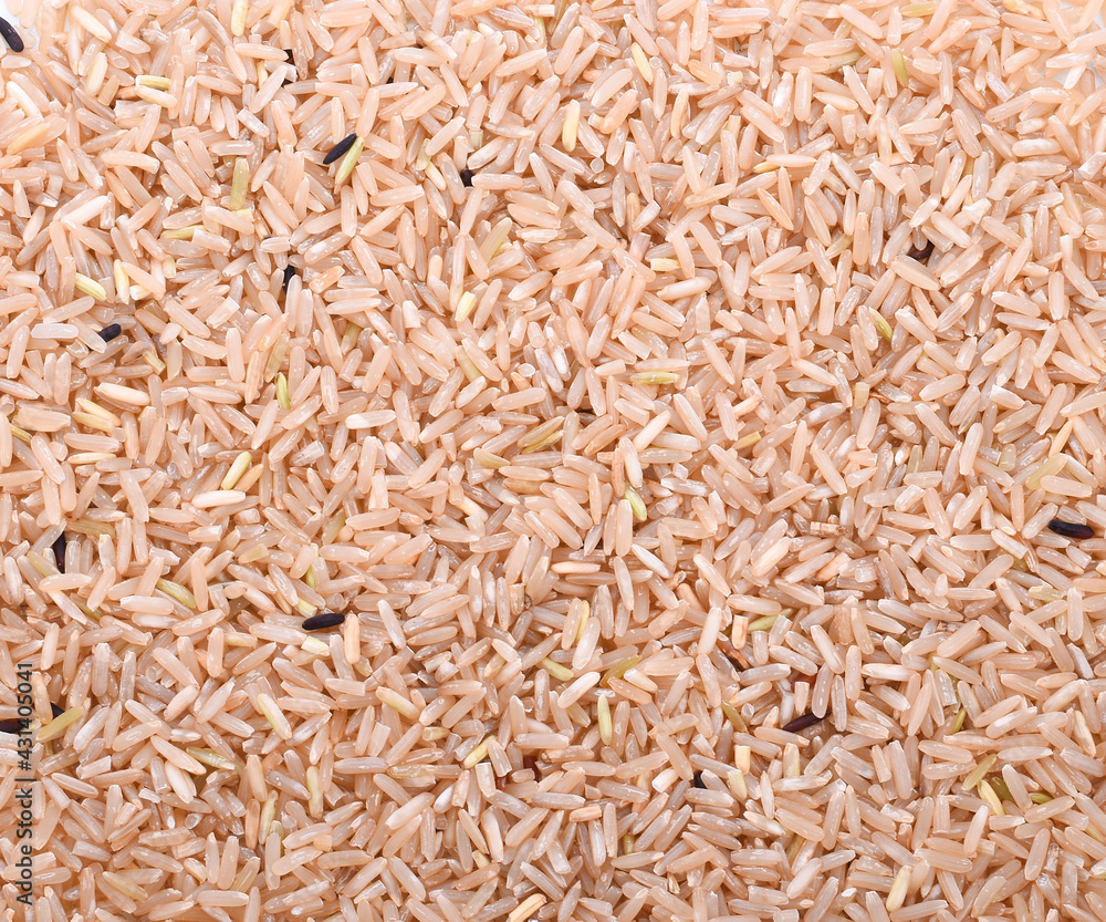 Pile of brown rice isolated on white background. Closeup.