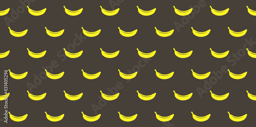 Endless seamless pattern with ripe yellow bananas on a black background. Wallpaper with windy bananas.