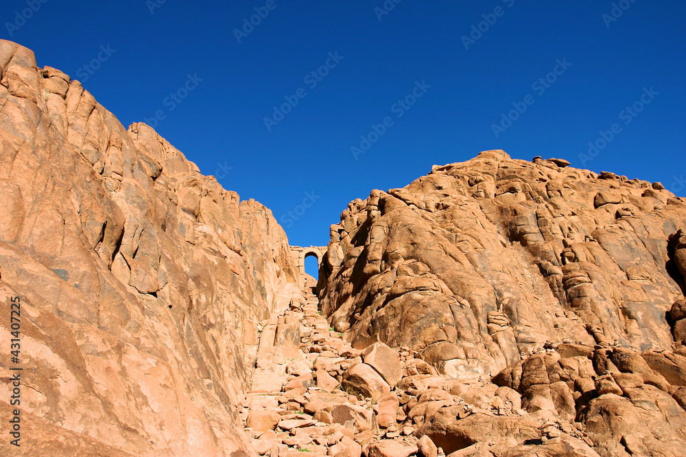 Door made of stones at the top of the mountain footpath in Mt Sinai in the Sinai desert. Egypt
