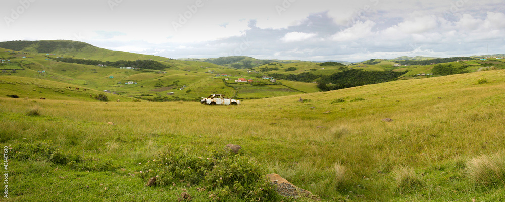 Panoramic view of a wreck car in the middle of a field on the way to Durban. Wild coast - South Africa