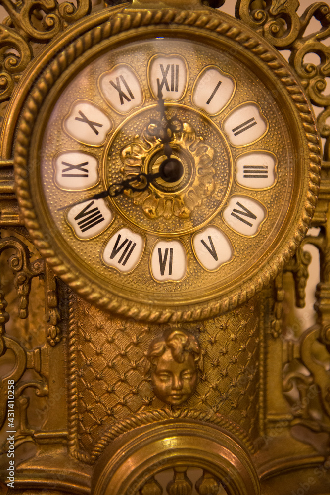Classical old yellow iron clock made in nineteenth century