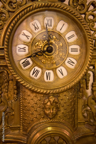 Classical old yellow iron clock made in nineteenth century