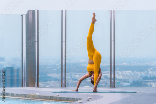 woman pratice yoga workout training pose show body flexibilty and balance photo