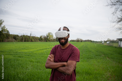 an African boy plays with his virtual reality headsets in a field. © Media Lens King