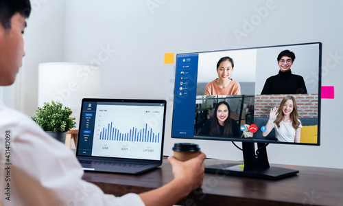 Businessman using laptop on table with making video call meeting to team online and present work projects. Concept working from home.