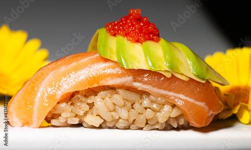 Niguiri of salmon, avocado and ikra