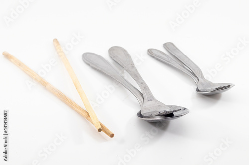 a spoon, fork and chopstick isolated on white background