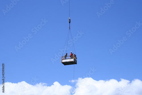 Workers lift clouds