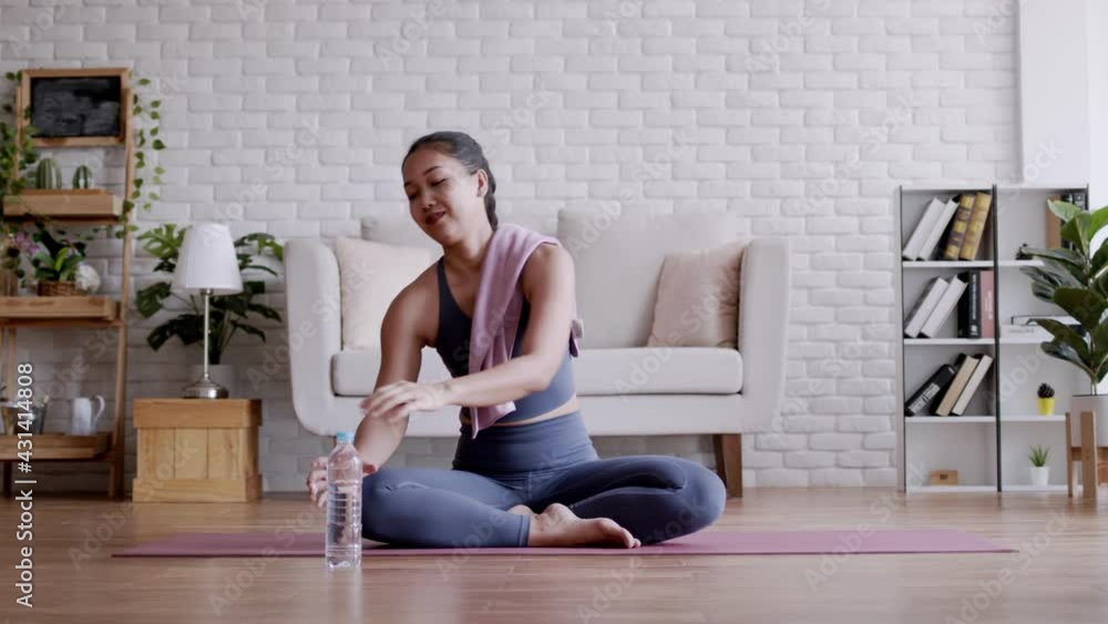 Asian woman drinking fresh water after pilates exercise yoga. Asian woman drinking fresh water after pilates exercise yoga.