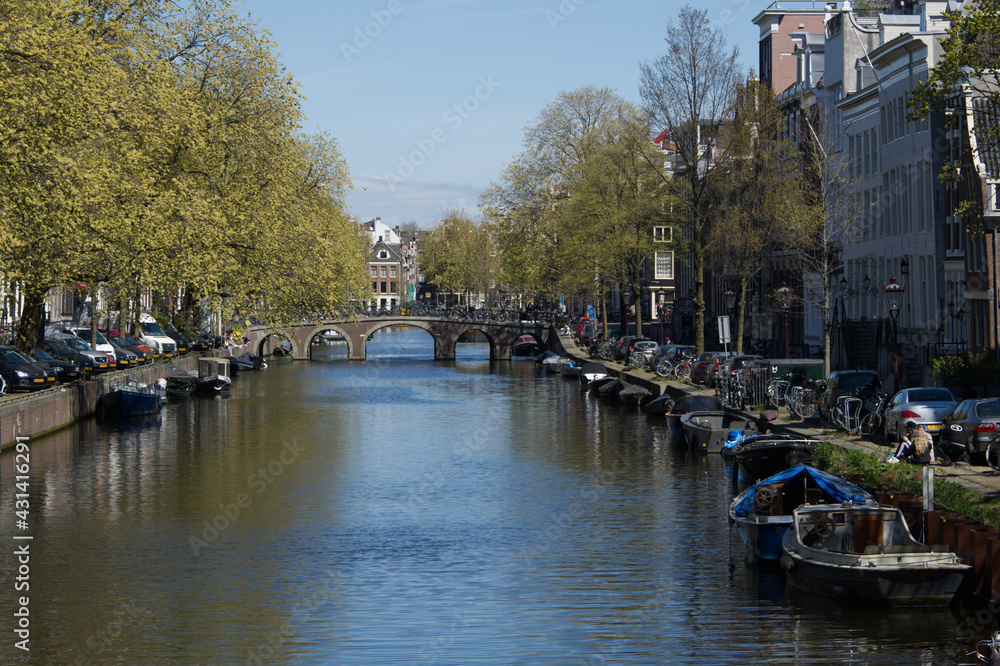 A warm sunny spring day in downtown Amsterdam Holland along the canal system.