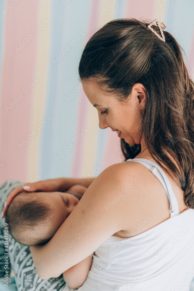 Young mother is breastfeeding her baby. In Vitro Fertilization IVF . Family of asians Young mother is breastfeeding her baby. In Vitro Fertilization IVF . Family of asians