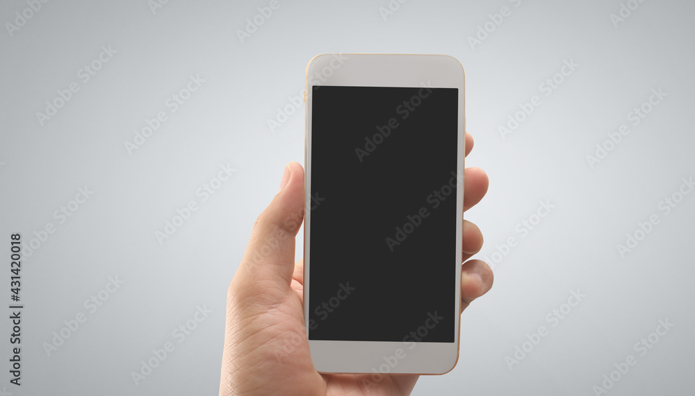 Hand holding smartphone device touching screen Hand holding smartphone device touching screen