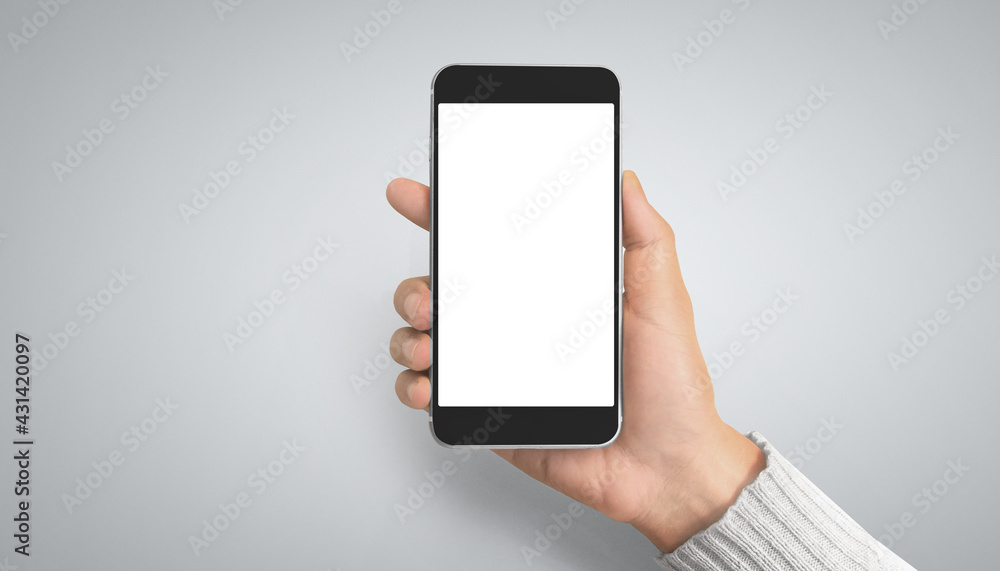 Hand holding smartphone device touching screen Hand holding smartphone device touching screen