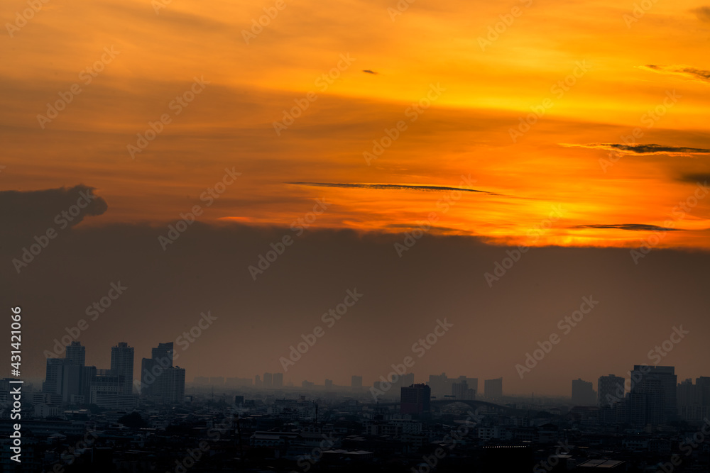 The blurred abstract background of the morning sun exposure to the tiny dust particles that surround the tall buildings in the capital, the long-term health issue of pollution.