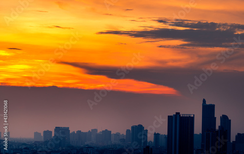 The blurred abstract background of the morning sun exposure to the tiny dust particles that surround the tall buildings in the capital, the long-term health issue of pollution.