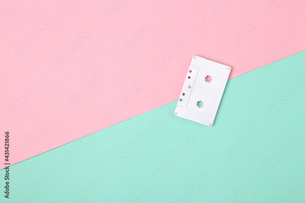 Minimalism creative layout. White audio cassette on pink blue background. Minimalism. Top view. Flat lay Minimalism creative layout. White audio cassette on pink blue background. Minimalism. Top view. Flat lay