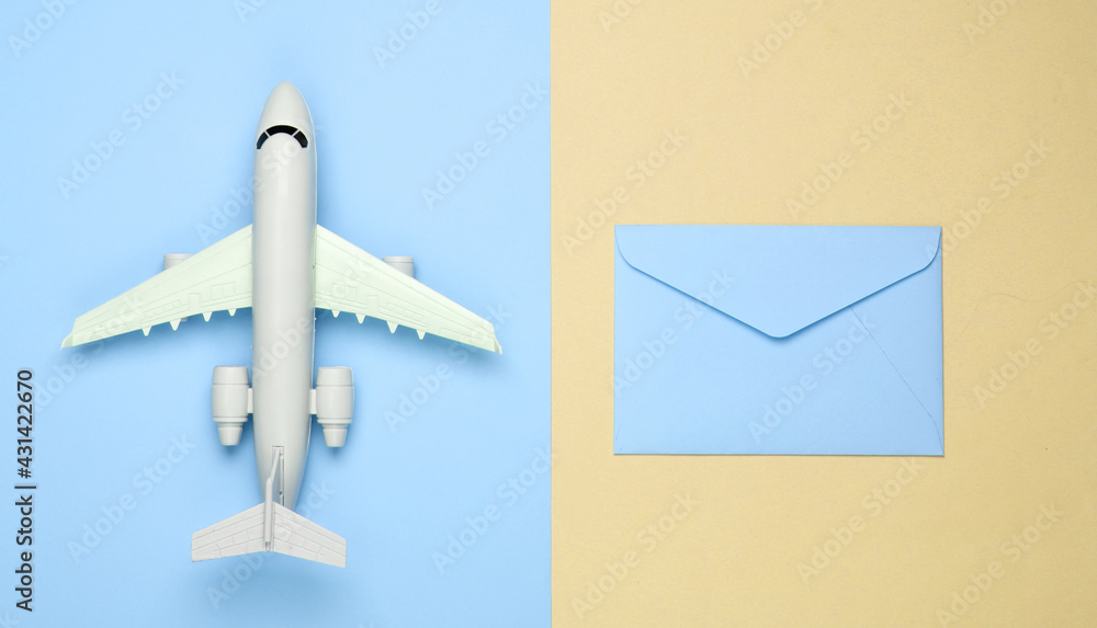 Air mail, air delivery. Flat lay composition with airplane figure and envelopes of letters on yellow blue pastel background. Top view