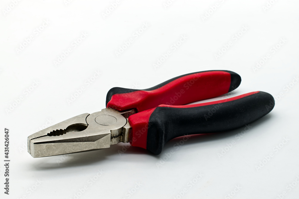 Metal hand pliers with red and black rubber handless isolated on white background Metal hand pliers with red and black rubber handless isolated on white background