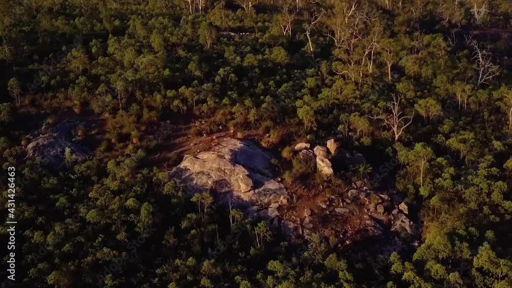 aerial pull back from rock outcrop on Australian bush hillside aerial pull back from rock outcrop on Australian bush hillside