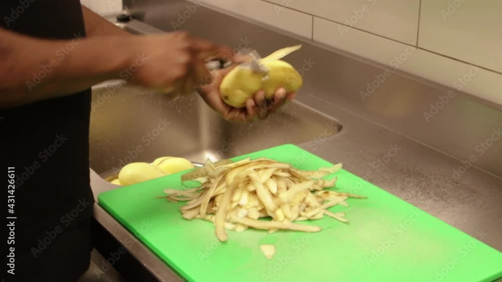 Chef de Partie peeling potatoes Chef de Partie peeling potatoes
