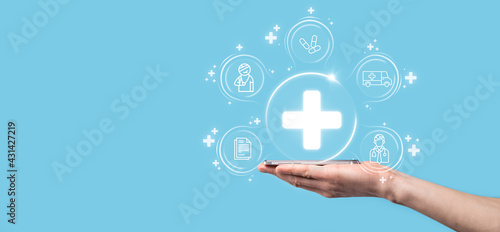 Businessman hold virtual plus medical network connection icons. Covid-19 pandemic develop people awareness and spread attention on their healthcare.Doctor,document,medicine,ambulance,patient icon.