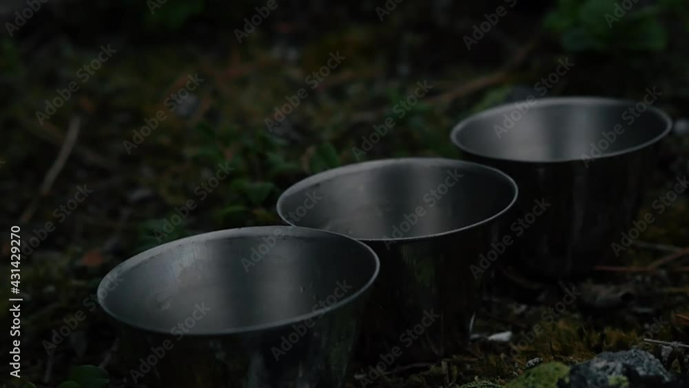 Close up of 3 shotglasses being filled with rum in nature Close up of 3 shotglasses being filled with rum in nature