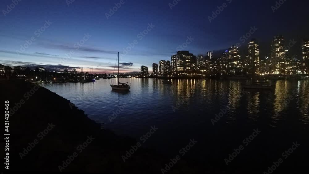 Timelapse of the evening Vancouver downtown and anchored yacht Timelapse of the evening Vancouver downtown and anchored yacht