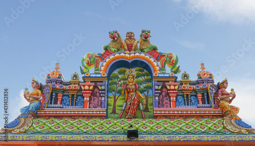 Indian traditional Goddess Mariyamman statue on temple tower 