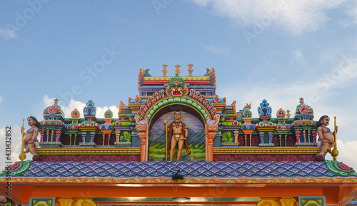 Hindu gaod murugan statue on temple roof top in India photo