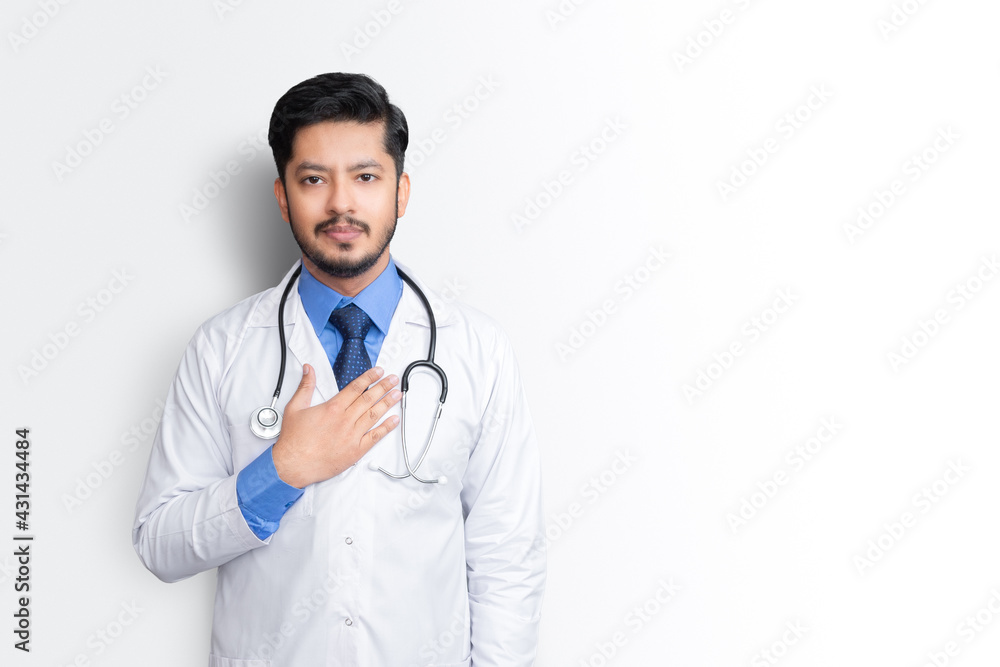 Portrait of male doctor with stethoscope & arm on chest isolated on white background. Health insurance concept. Portrait of male doctor with stethoscope & arm on chest isolated on white background. Health insurance concept.