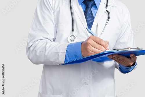 Doctor in lab coat holding and writing patient file or medical notes looking, isolated on white background