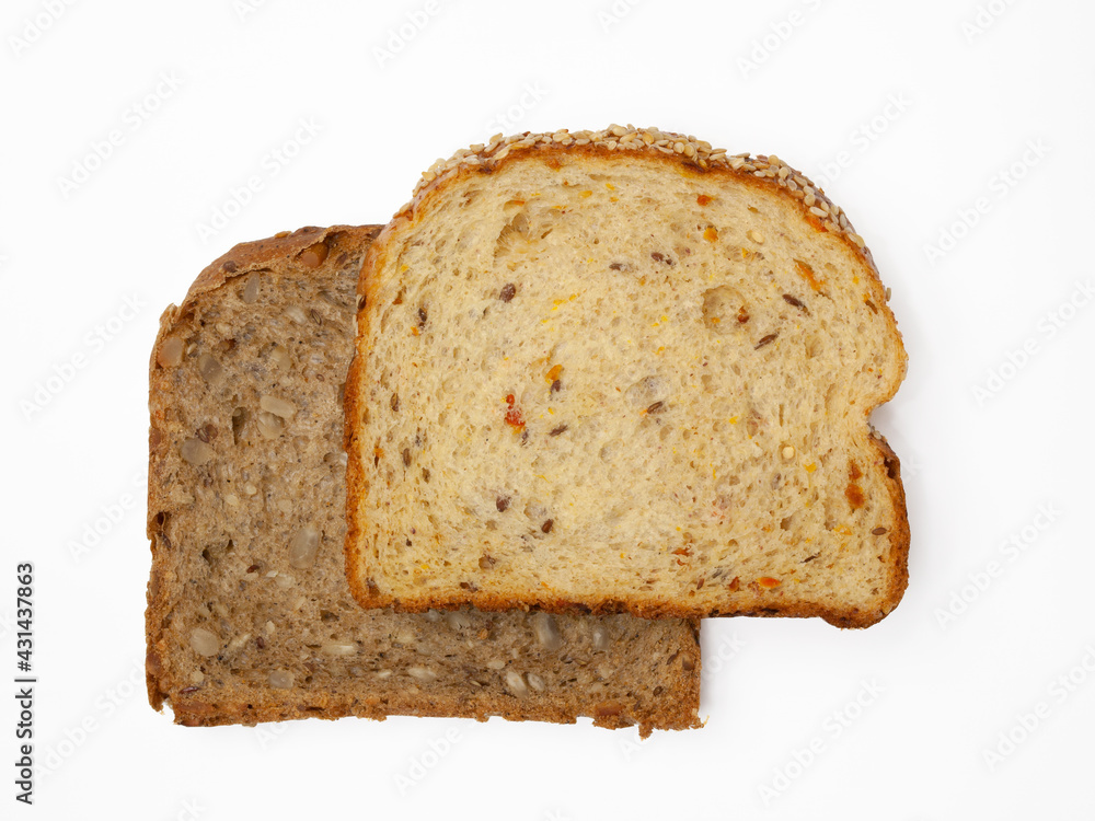 Two slices of wholegrain bread with vegetables and seeds of sunflower, flax, and sesame. Healthy vegetarian food. Isolated flatlay. Two slices of wholegrain bread with vegetables and seeds of sunflower, flax, and sesame. Healthy vegetarian food. Isolated flatlay.
