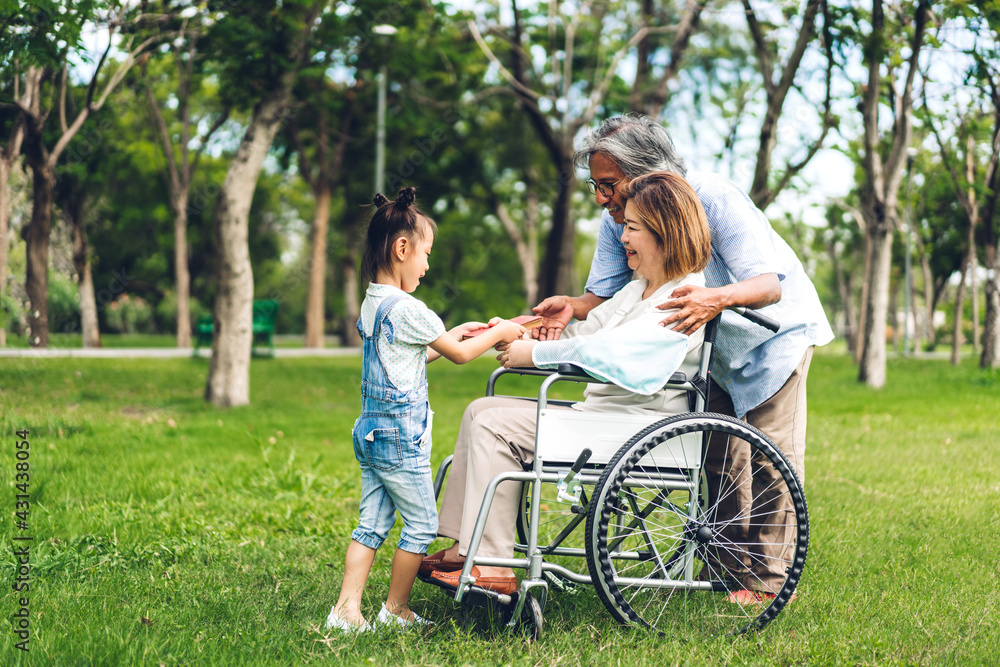 Portrait of happy asian grandfather with grandmother and asian little cute girl enjoy relax in summer park.Young girl with their laughing grandparents smiling together.Family and togetherness Portrait of happy asian grandfather with grandmother and asian little cute girl enjoy relax in summer park.Young girl with their laughing grandparents smiling together.Family and togetherness