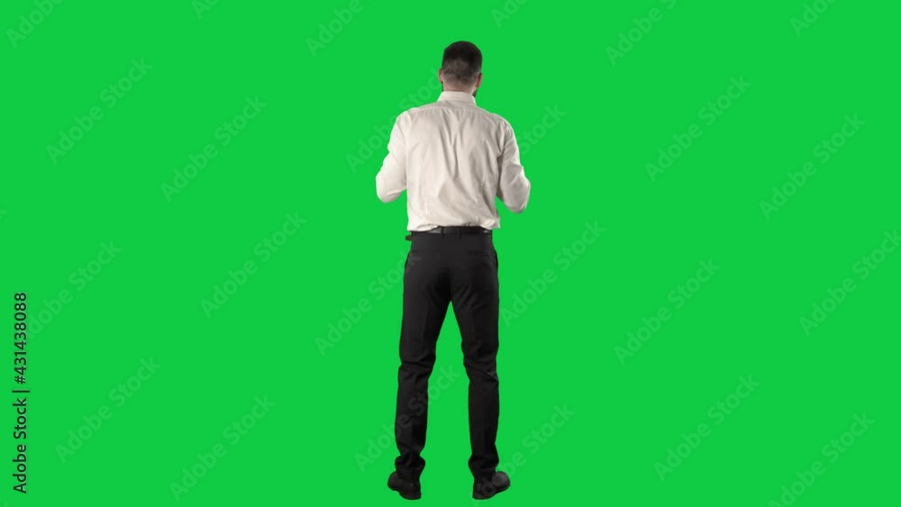 Back view of business man fan or supporter cheering and rooting clapping hands. Full length on green screen chroma key background. Back view of business man fan or supporter cheering and rooting clapping hands. Full length on green screen chroma key background.