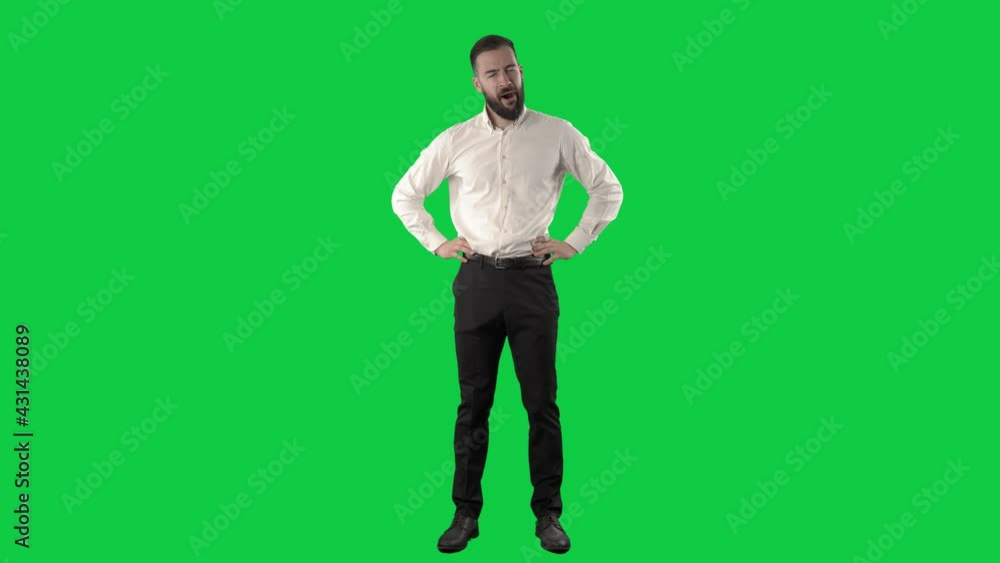 Overworked tired sleepy business man yawning and rubbing eyes having headache. Full length on green screen chroma key background. Overworked tired sleepy business man yawning and rubbing eyes having headache. Full length on green screen chroma key background.