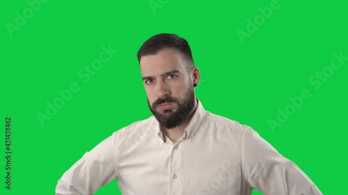 Annoyed displeased business man shaking head and rolling eyes looking at camera. Portrait on green screen background.