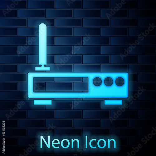 Glowing neon Router and wi-fi signal icon isolated on brick wall background. Wireless ethernet modem router. Computer technology internet. Vector