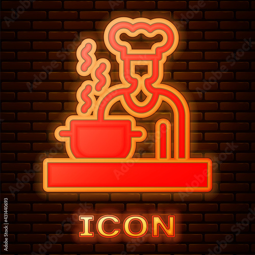 Glowing neon Spanish cook icon isolated on brick wall background. Vector