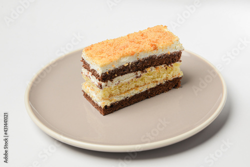 A piece of a layered cake with sour cream. Traditional recipe of Smetannik  sweet cream cake.