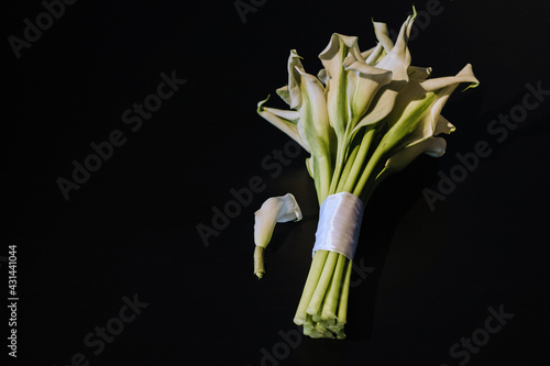 Wedding bouquet of white Calla lilies on a black background